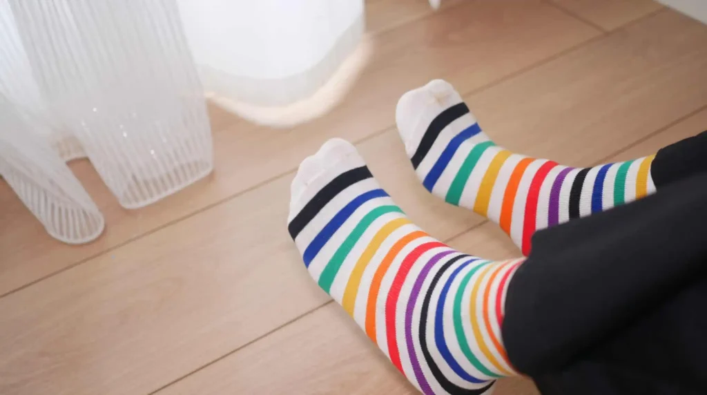 adult putting on sensory socks seamless sensory socks being worn showing tagless cuff and flat toe construction