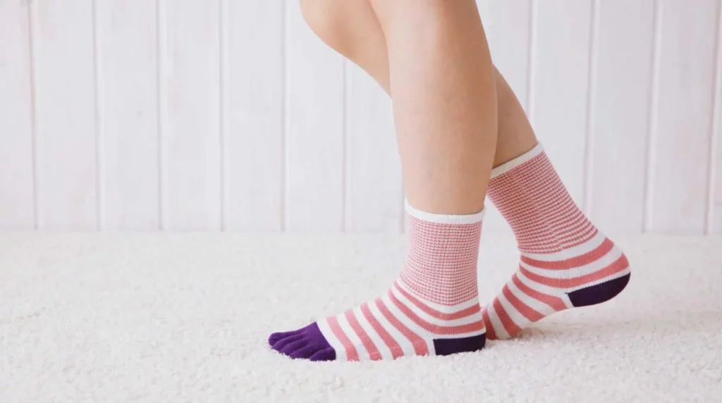close-up of adult wearing sensory sock flat seamless toe sensory sock inside shoe showing no irritation